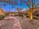 Landscaped backyard with a stone pathway and lighting at 3 Palmbrook Ln, Henderson, NV 89052