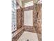 Elegant bathroom with marble shower, glass block feature, and built-in bench at 3 Palmbrook Ln, Henderson, NV 89052