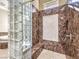 Spa-like bathroom with marble shower, glass block feature, and built-in bench at 3 Palmbrook Ln, Henderson, NV 89052