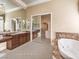 Primary bathroom with soaking tub, walk-in shower, and dual sinks at 3 Palmbrook Ln, Henderson, NV 89052