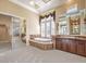 Luxurious bathroom with a large soaking tub and walk-in closet at 3 Palmbrook Ln, Henderson, NV 89052