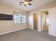 Large bedroom with ceiling fan, window, and built-in shelving at 3 Palmbrook Ln, Henderson, NV 89052