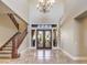 Elegant two-story entryway with a chandelier and hardwood staircase at 3 Palmbrook Ln, Henderson, NV 89052