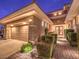 Three-car garage with stone accents and landscaping at 3 Palmbrook Ln, Henderson, NV 89052