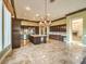 Open concept kitchen with island, dark cabinetry, and granite counters at 3 Palmbrook Ln, Henderson, NV 89052