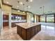 Island kitchen features granite countertops and dark wood cabinets at 3 Palmbrook Ln, Henderson, NV 89052