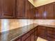 Kitchen boasts dark wood cabinets and granite countertops at 3 Palmbrook Ln, Henderson, NV 89052