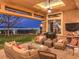 Outdoor patio with seating area and stunning nighttime city views at 3 Palmbrook Ln, Henderson, NV 89052