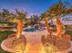 Relaxing pool area with palm trees and city views at dusk at 3 Palmbrook Ln, Henderson, NV 89052