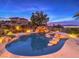 Resort-style pool and spa with rock waterfall, offering stunning city views at 3 Palmbrook Ln, Henderson, NV 89052