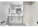 Updated bathroom with white cabinets and a bathtub at 3490 Allegheny Dr, Las Vegas, NV 89122