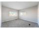 Well-lit bedroom with grey carpet and two windows at 3490 Allegheny Dr, Las Vegas, NV 89122