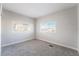 Spacious bedroom with grey carpet and two windows at 3490 Allegheny Dr, Las Vegas, NV 89122