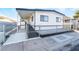 White single-wide manufactured home with covered carport and chain link fence at 3490 Allegheny Dr, Las Vegas, NV 89122