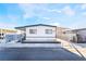 Front view of a remodeled manufactured home with a carport and fenced yard at 3490 Allegheny Dr, Las Vegas, NV 89122