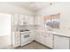 Modern white kitchen with gas stove and microwave at 3837 Willowview Ct, Las Vegas, NV 89147