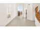 High ceiling living room with tile floors and staircase at 3837 Willowview Ct, Las Vegas, NV 89147