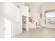 High ceiling living room with tile floors and staircase at 3837 Willowview Ct, Las Vegas, NV 89147