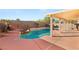 Inviting backyard oasis with a sparkling pool and covered patio at 3837 Willowview Ct, Las Vegas, NV 89147