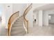 Elegant curved staircase with wooden railings at 3837 Willowview Ct, Las Vegas, NV 89147