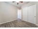 Neutral bedroom featuring wood-look tile flooring, a ceiling fan, and a closet with sliding doors at 421 Point Sur Ave, Las Vegas, NV 89138