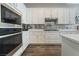 Modern kitchen with white cabinets, mosaic backsplash, and stainless steel appliances at 421 Point Sur Ave, Las Vegas, NV 89138