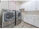 Convenient laundry room featuring modern appliances, ample counter space and overhead cabinetry at 421 Point Sur Ave, Las Vegas, NV 89138