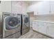 Laundry room with LG washer and dryer, and white cabinets at 421 Point Sur Ave, Las Vegas, NV 89138