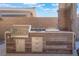 The outdoor kitchen features a built-in grill, storage, and prep space for outdoor entertaining at 421 Point Sur Ave, Las Vegas, NV 89138