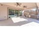 An outdoor kitchen sits adjacent to a covered patio with ceiling fans and sliding glass doors at 421 Point Sur Ave, Las Vegas, NV 89138