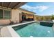 Resort-style backyard includes a large pool, hot tub, covered patio, and outdoor seating areas at 421 Point Sur Ave, Las Vegas, NV 89138