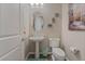Cozy powder room showcasing a pedestal sink, decorative mirror and fixtures at 421 Point Sur Ave, Las Vegas, NV 89138