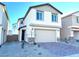 Two-story house with neutral color scheme and a two-car garage at 4763 Illustria Ave, Las Vegas, NV 89141