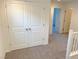 Bright hallway with double doors and carpet flooring at 4763 Illustria Ave, Las Vegas, NV 89141