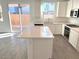 Modern kitchen with island, stainless steel appliances, and backyard access at 4763 Illustria Ave, Las Vegas, NV 89141