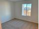 Well-lit bedroom featuring neutral wall paint and carpet at 4771 Illustria Ave, Las Vegas, NV 89141