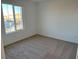 Bright bedroom with large window and neutral carpeting at 4771 Illustria Ave, Las Vegas, NV 89141