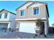 Two-story house with white garage door, light beige exterior, and landscaping at 4771 Illustria Ave, Las Vegas, NV 89141