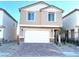 Two-story house with a white garage door and brick accents at 4771 Illustria Ave, Las Vegas, NV 89141