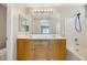 Bathroom with double vanity, large mirror, and bathtub at 5064 Sacred Datura Ave, Las Vegas, NV 89139