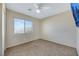 Bedroom with window, ceiling fan, and carpet at 5064 Sacred Datura Ave, Las Vegas, NV 89139