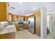 Kitchen with stainless steel appliances and wood cabinets at 5064 Sacred Datura Ave, Las Vegas, NV 89139