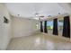 Spacious living room with tile floors and a ceiling fan at 5064 Sacred Datura Ave, Las Vegas, NV 89139