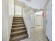 Staircase with carpeted steps and a white railing leading to the upper level at 5064 Sacred Datura Ave, Las Vegas, NV 89139