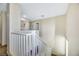 Upstairs hallway with white railing and access to other rooms at 5064 Sacred Datura Ave, Las Vegas, NV 89139