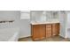 Double sink bathroom with wood cabinets and tile flooring at 5332 Iron Crossing Ave, Las Vegas, NV 89131