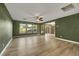 Living room with green walls, wood-look floors, and sliding glass doors at 5332 Iron Crossing Ave, Las Vegas, NV 89131