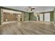 Living room with hardwood floors, olive green walls, and staircase at 5332 Iron Crossing Ave, Las Vegas, NV 89131