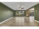 Living room with green walls, wood-look floors, and sliding glass doors at 5332 Iron Crossing Ave, Las Vegas, NV 89131