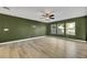 Living room with green walls, wood-look floors, and sliding glass doors at 5332 Iron Crossing Ave, Las Vegas, NV 89131